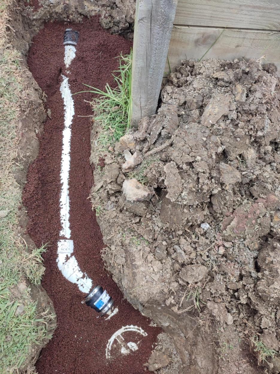 New drain pipe installed in scoria bedding in a trench on a South Auckland property